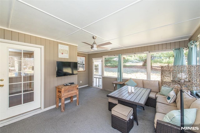 carpeted living room with baseboards and ceiling fan