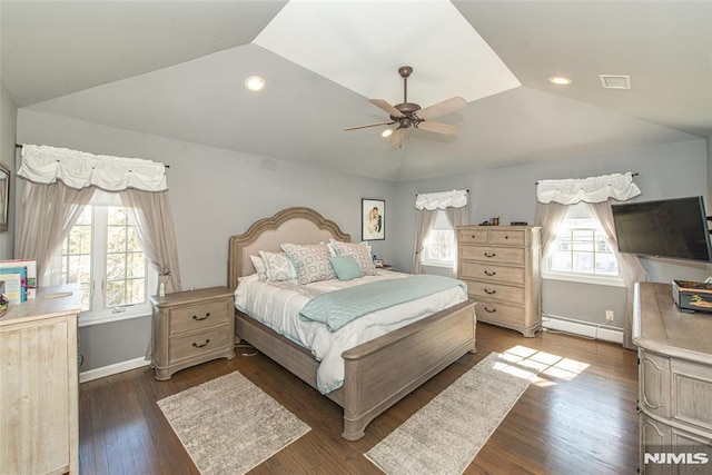 bedroom with wood finished floors, visible vents, baseboards, vaulted ceiling, and a baseboard heating unit