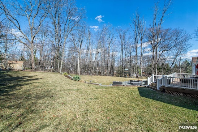 view of yard with a wooden deck