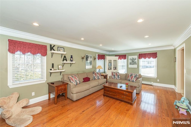 living area with baseboards, hardwood / wood-style floors, ornamental molding, recessed lighting, and a baseboard radiator