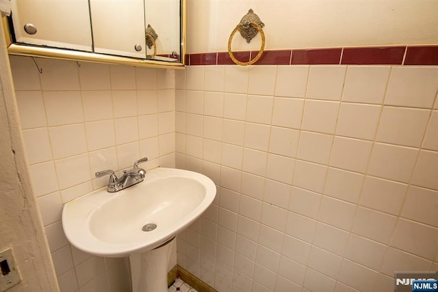 bathroom with tile walls