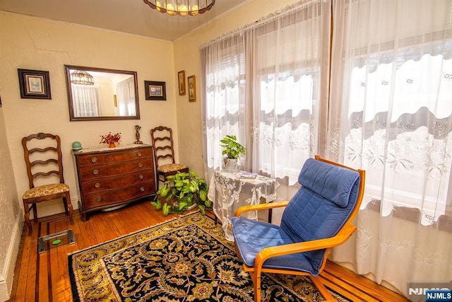 sitting room featuring hardwood / wood-style floors and ornamental molding