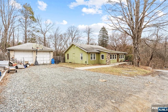 view of side of home featuring a detached garage and an outdoor structure