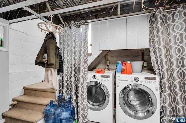 laundry room with cabinet space and washing machine and clothes dryer