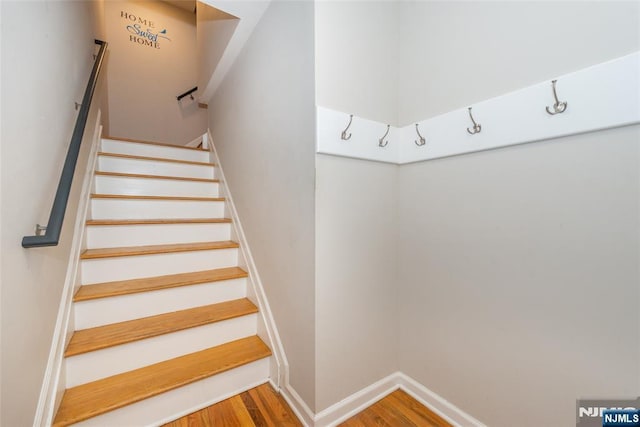 stairs featuring baseboards and wood finished floors