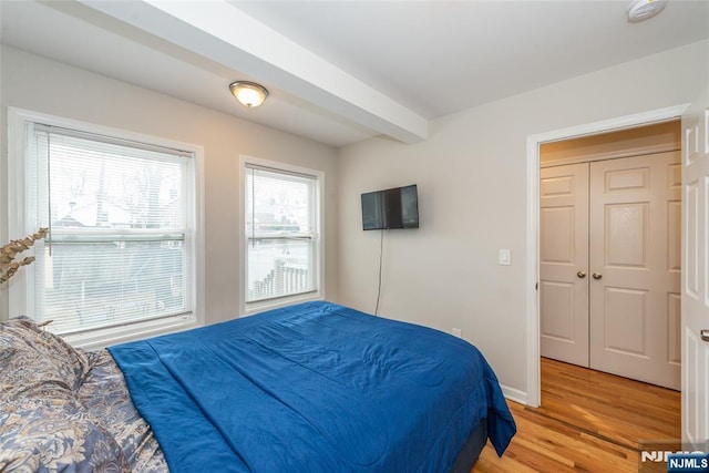 bedroom featuring baseboards and light wood-style flooring