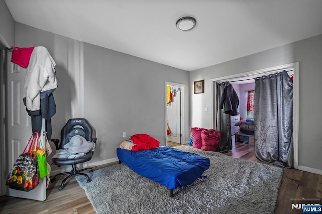 bedroom featuring wood finished floors and baseboards