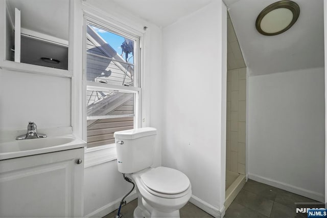 full bathroom featuring a shower stall, toilet, vanity, and baseboards