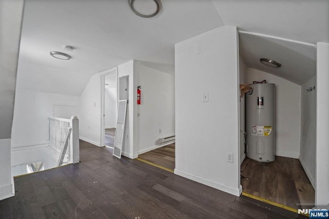 additional living space with lofted ceiling, wood finished floors, and water heater