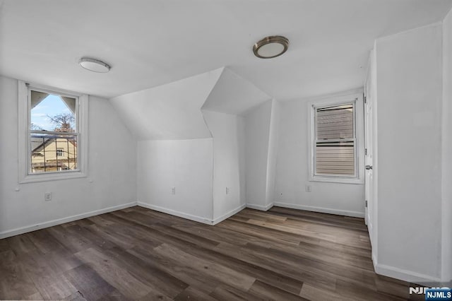 bonus room featuring baseboards, lofted ceiling, and wood finished floors