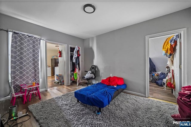 playroom featuring baseboards and wood finished floors