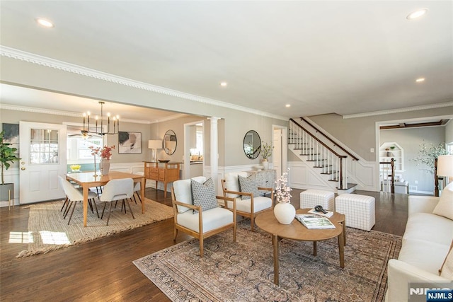 living area with dark wood finished floors, a wainscoted wall, recessed lighting, and stairs