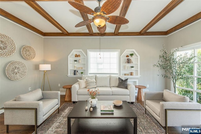 living room with beam ceiling, dark wood-style flooring, and a ceiling fan