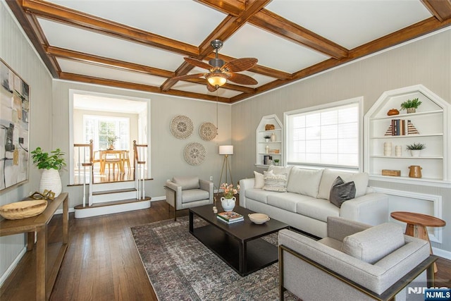 living area with dark wood-style floors, beamed ceiling, coffered ceiling, and ceiling fan