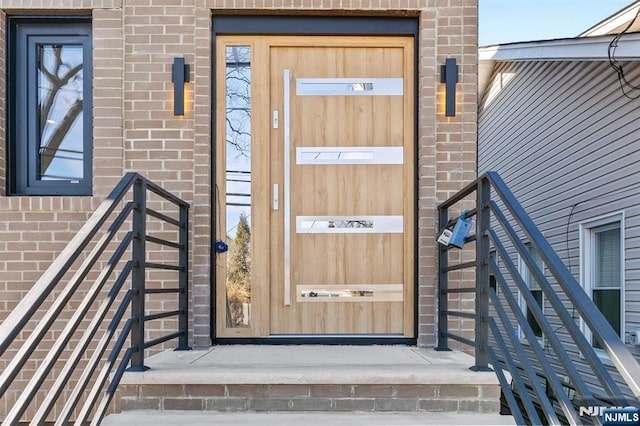 property entrance with brick siding