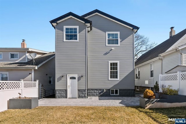 rear view of property with a patio area, fence, and a lawn