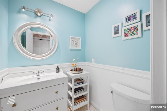 bathroom featuring toilet and vanity