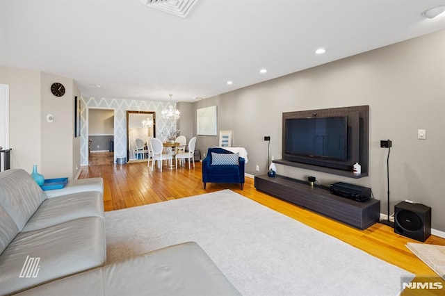 living room with visible vents, a notable chandelier, wood finished floors, recessed lighting, and baseboards