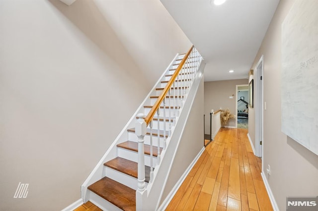 stairs featuring recessed lighting, baseboards, and wood-type flooring