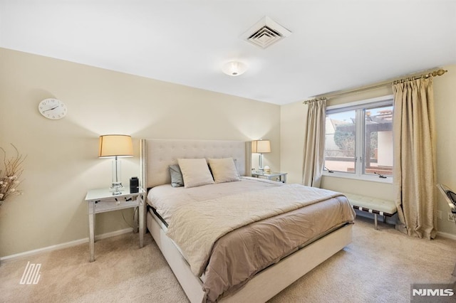 bedroom with light carpet, visible vents, and baseboards