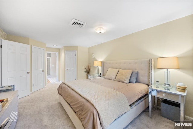 bedroom with light colored carpet and visible vents