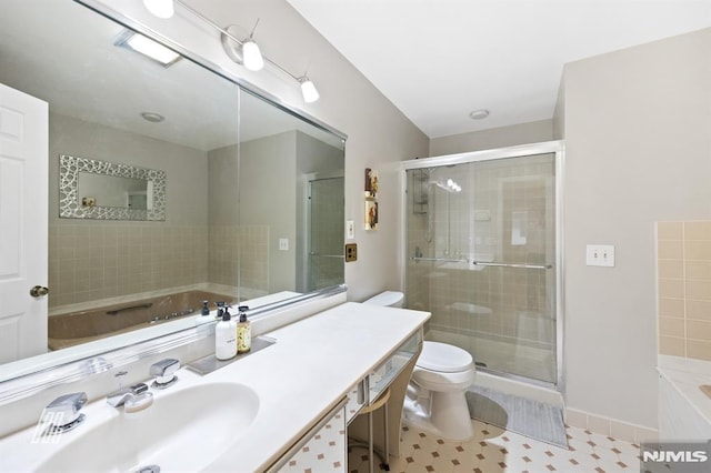 full bath with toilet, a garden tub, a stall shower, tile patterned floors, and vanity