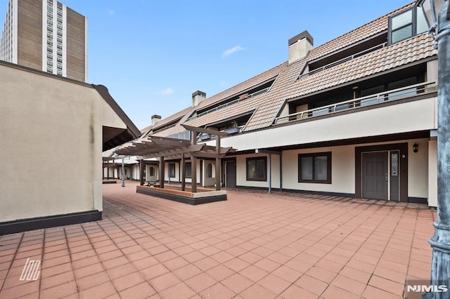 view of patio featuring a balcony