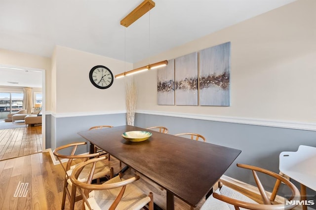 dining area with hardwood / wood-style flooring and baseboards