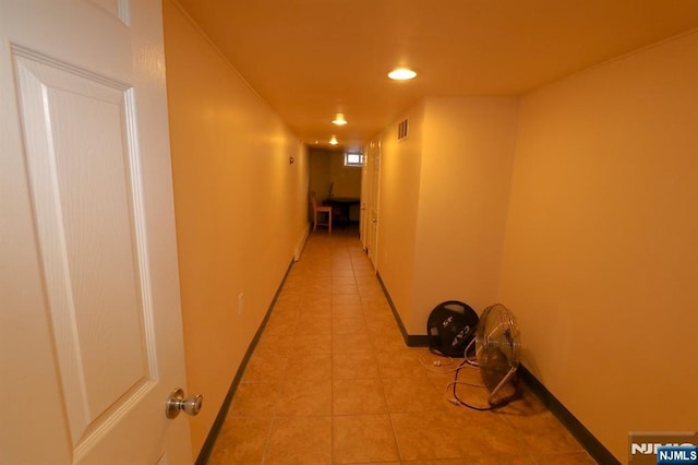 hall with light tile patterned flooring, visible vents, recessed lighting, and baseboards