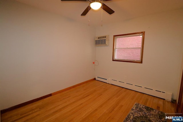 unfurnished room with baseboards, ceiling fan, an AC wall unit, light wood-style floors, and a baseboard radiator