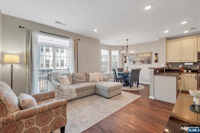 living room featuring recessed lighting, visible vents, a healthy amount of sunlight, and dark wood-type flooring