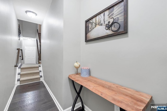 stairs featuring baseboards and wood finished floors