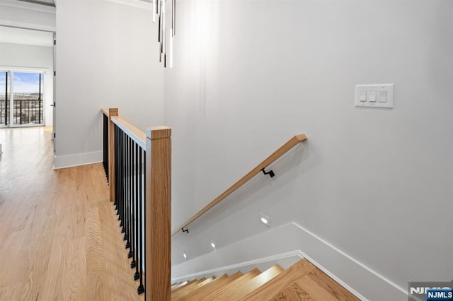 stairs featuring baseboards and wood finished floors