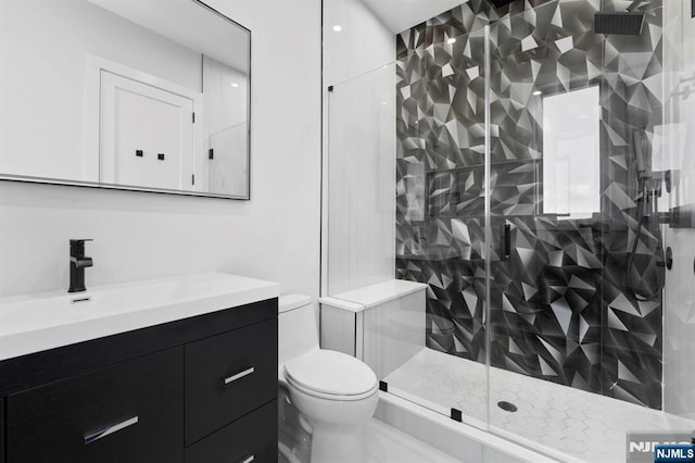 full bathroom with a shower stall, toilet, and vanity