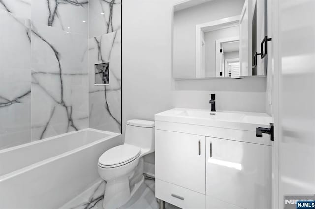 bathroom with toilet, marble finish floor, shower / washtub combination, and vanity