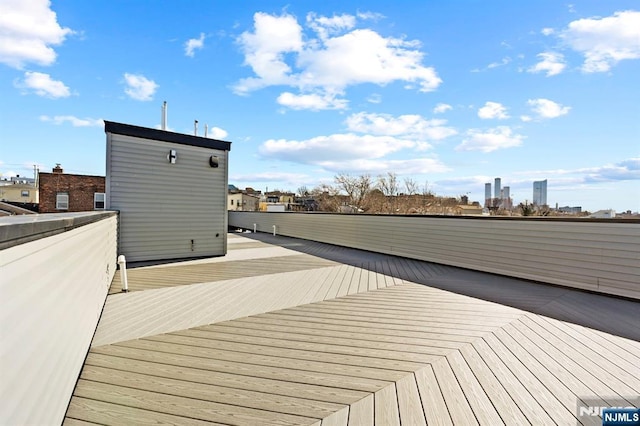 wooden terrace featuring a view of city