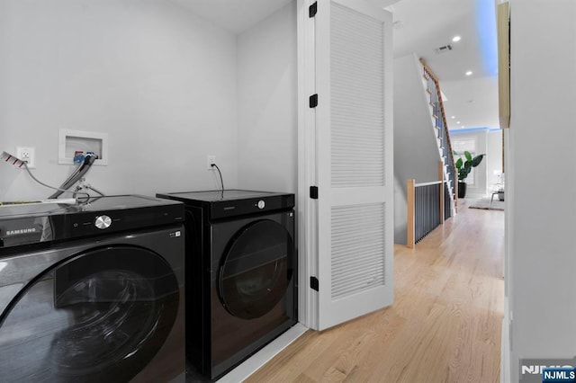 washroom with visible vents, light wood finished floors, laundry area, recessed lighting, and washing machine and dryer