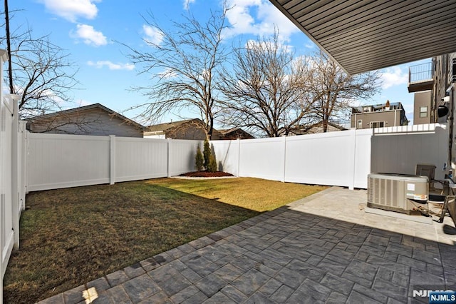 view of yard featuring a patio area, cooling unit, and a fenced backyard