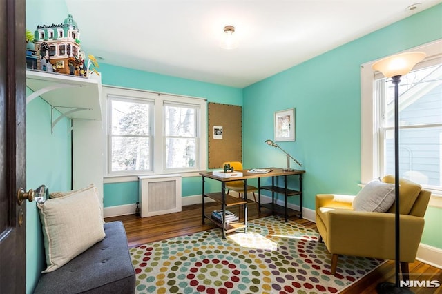 office area with baseboards and wood finished floors