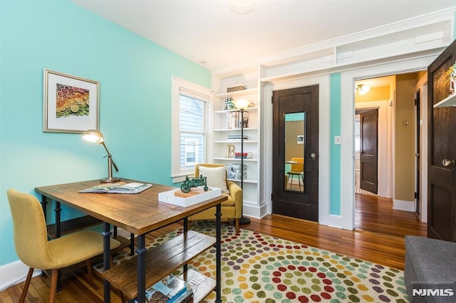 office area featuring baseboards and wood finished floors