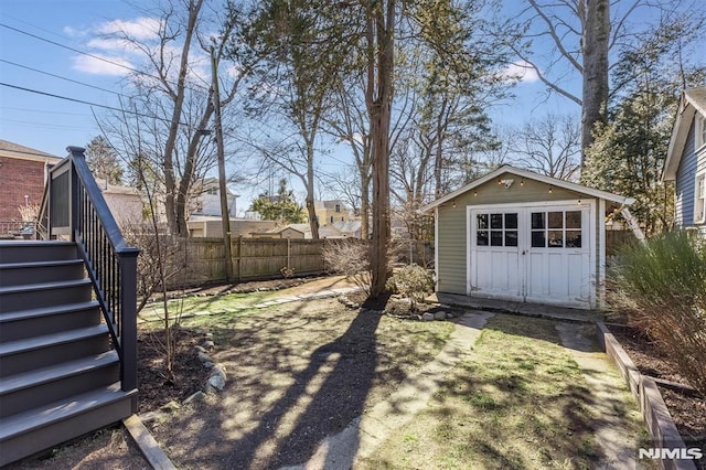 view of yard featuring stairway, a shed, an outdoor structure, and fence