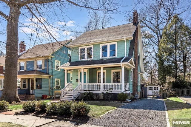 view of front of property with a porch, fence, gravel driveway, a shingled roof, and a chimney