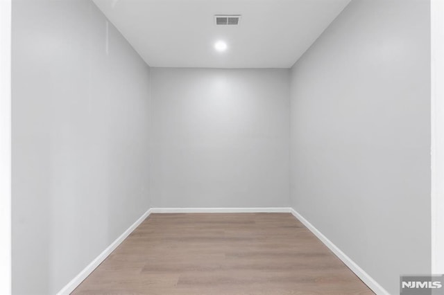 interior space featuring light wood-style floors, visible vents, and baseboards