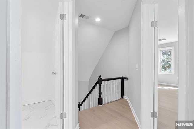 stairway featuring recessed lighting, visible vents, marble finish floor, and baseboards