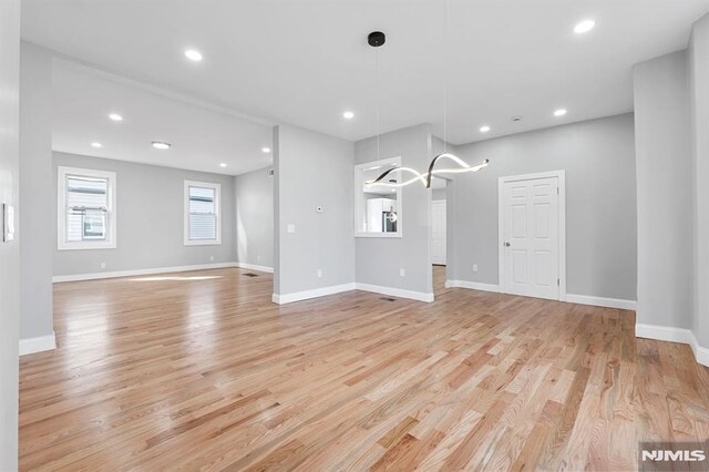 interior space with recessed lighting, light wood-type flooring, and baseboards