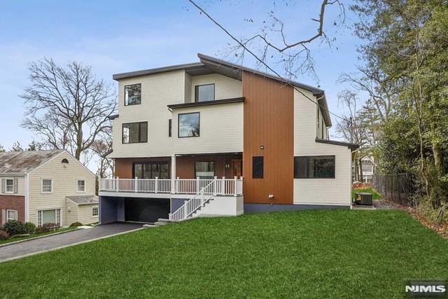 rear view of property featuring a lawn