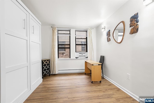 interior space featuring light wood-style floors, baseboards, and baseboard heating