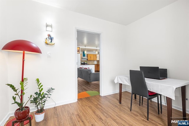 office featuring baseboards and wood finished floors