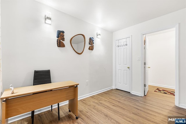 office featuring baseboards and light wood finished floors