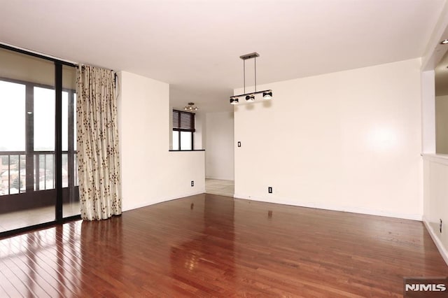 interior space with a wall of windows, baseboards, and wood-type flooring